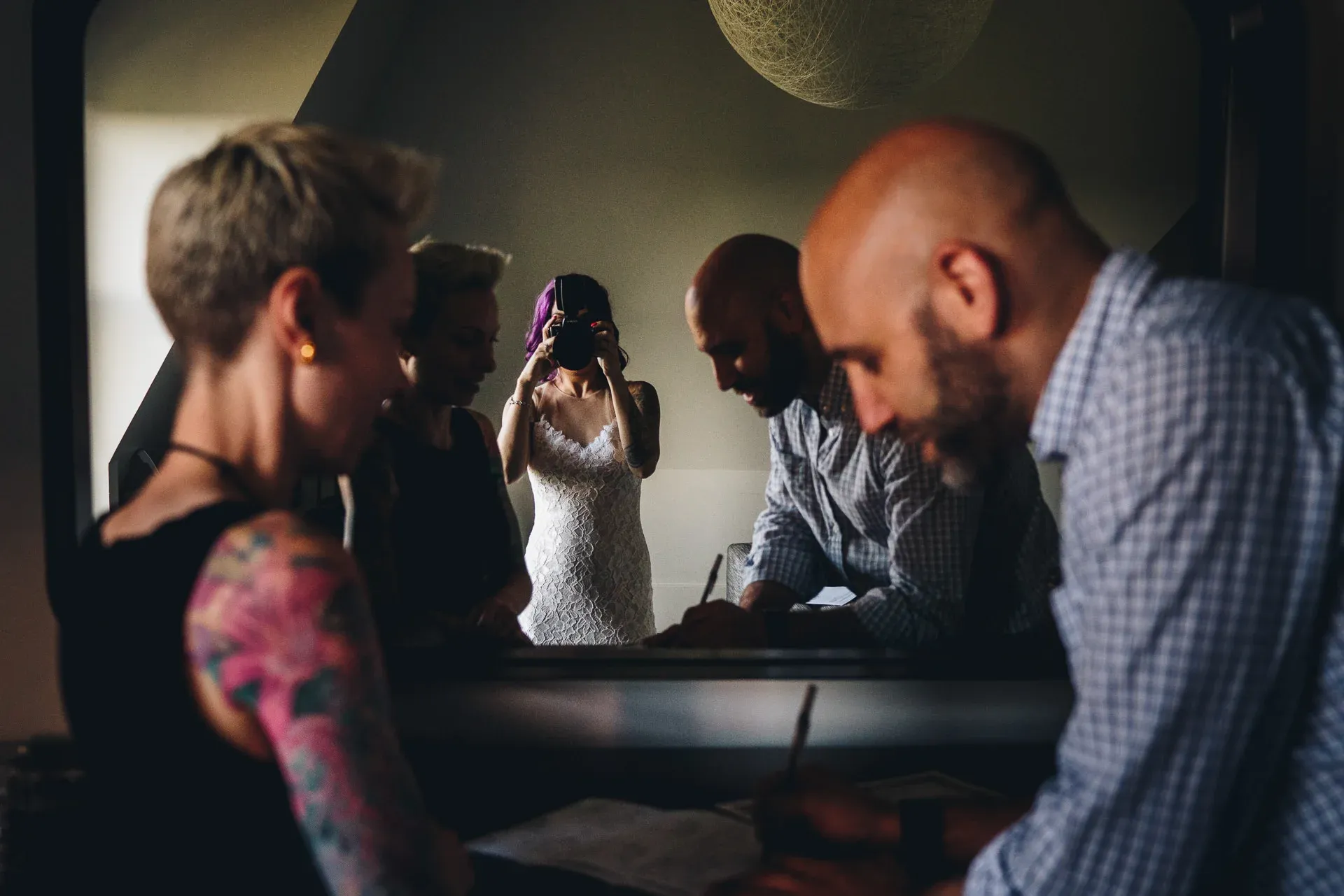 The photo we used as episode art is from Andy Buscemi. He's actually the guy signing the marriage license in the photo (as the witness). His bride picked up his camera after he set it down and took a photo of him (and we love that story).